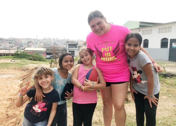 Kristen with youngsters from her previous mission trip. 