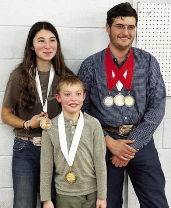 Menard Rifles medal at Heart of Texas match: (l-r) Mia Estrada, Walker Hines and Larkin Loeffler. Courtesy photo.