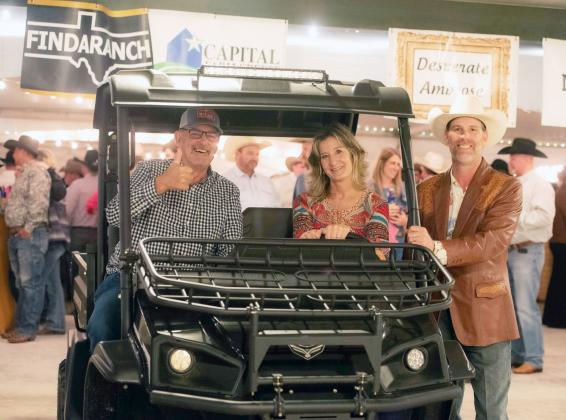 ELATED UTV WINNERS Lawton and Cindy King, of Sweeny, Texas, claim their new American made Landstar L5 UTV (and trailer). Emcee Tyler Wright, pictured right, announced the winner Friday night at the Party at the Presidio fundraiser for Menard Public Library. Sandy Kothmann, photo.
