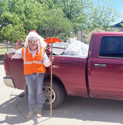 HEADDRESS AND SAFETY VEST secured, Chief Broken Eagle (Ray Hernandez) spent Earth Day picking up trash along his Adopt a Highway section of US 83 S. Chief collected a full pickup bed full of refuse off the side of the road. TMN photo.