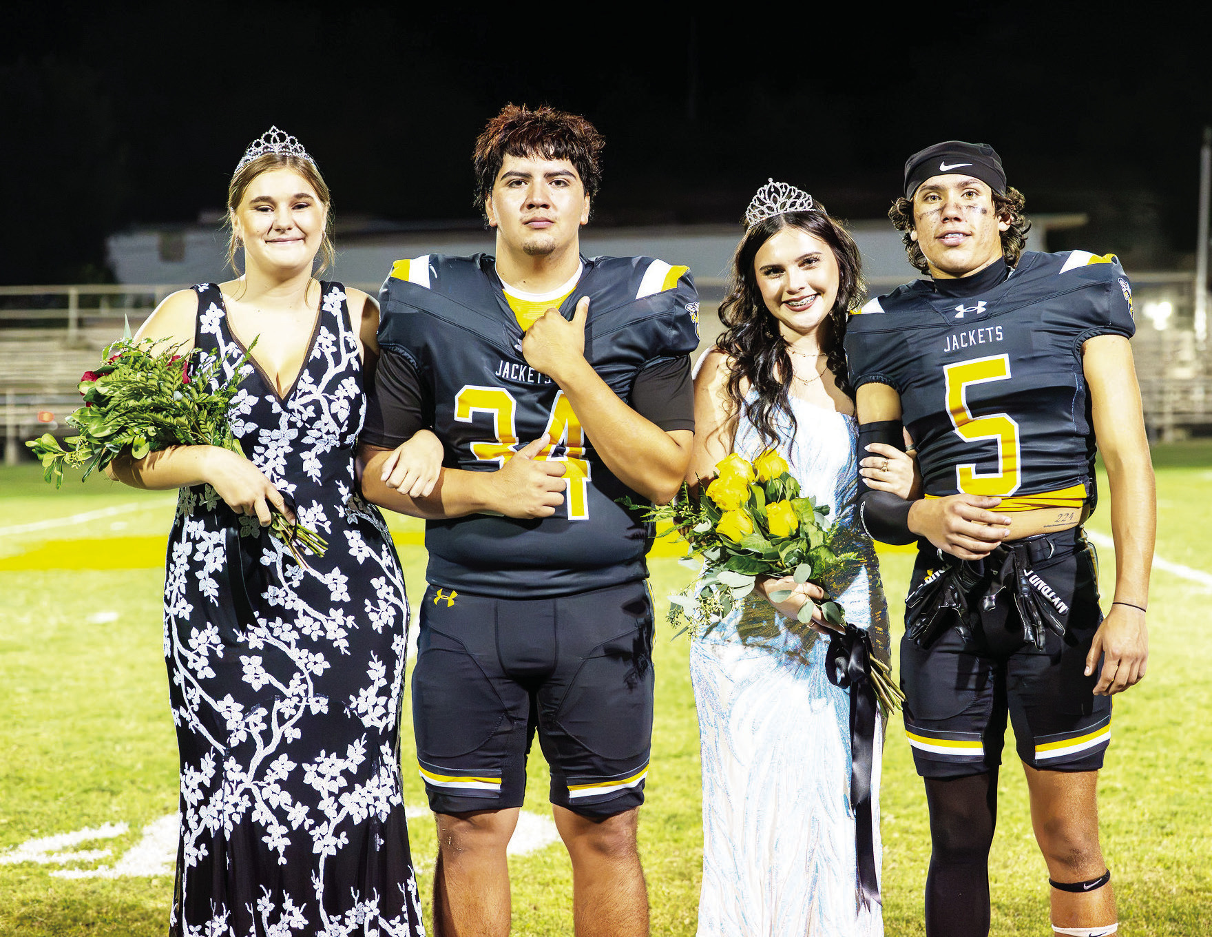 HOMECOMING ROYALTY- Newly crowned Band Sweetheart Kylee Sommerville, left, with her escort Joseph Garcia, stand alongside the new Football Queen, Sabri Zamora, with Marlee Salas after the ceremony following the Jackets’ 78-0 homecoming win over Paint Rock. See more on the homecoming court on pages 9 and 10. Nora Davis, photo.