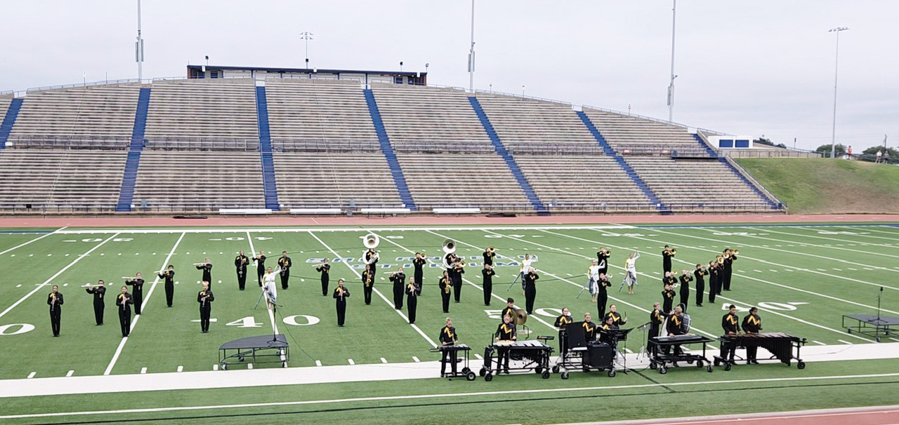 ABOVE- Menard’s award winning marching band swept the Concho Classic Marching Festival in San Angelo on Saturday winning Best Overall 1A Band, Best Brass, Best Woodwinds, Best Percussion and Best Color Guard. Myghan Meadow, photo. LEFT- Drum Major Kailey Morris displays the band’s pile of accomplishments from the Concho Classic at San Angelo Stadium this weekend. Courtesy photo.