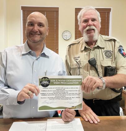 ABOVE- Menard County Judge Brandon Corbin is pictured after signing the Stewardship Week proclamation. Constable Lee Callan joined in.