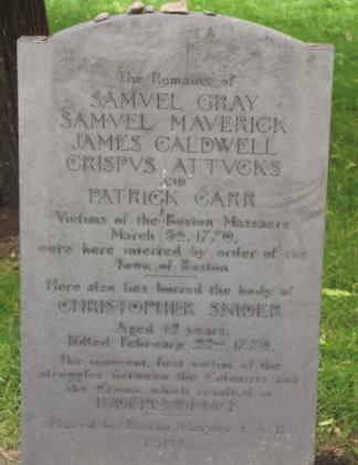 Right: The tomstone marking the grave of the 5 victims of the Boston Massacre that were buried together along with a 6th person from a previous related event. Old Granary Graveyard, Boston. Photo by Carl Lanning.