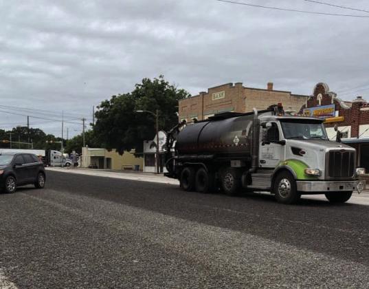 TxDOT contractors began chip seal (tar and gravel) coating Farm to Market Road FM 2092 late last week, reaching the town portion known as San Saba Avenue on Monday. The town portion was completed just in time for the rain. Chamber of Commerce photo.