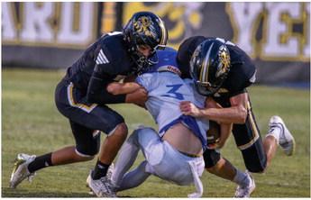 Jayden Payton and Wyatt Terrell take down a Cherokee Indian in last Friday’s game. Madolyn Nasworthy Photo.