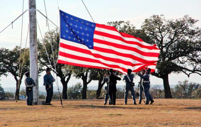 Ft. McKavett’s special event this weekend will include a flag raising similar to the one pictured above. Ft.McKavett State Historical Site photo.