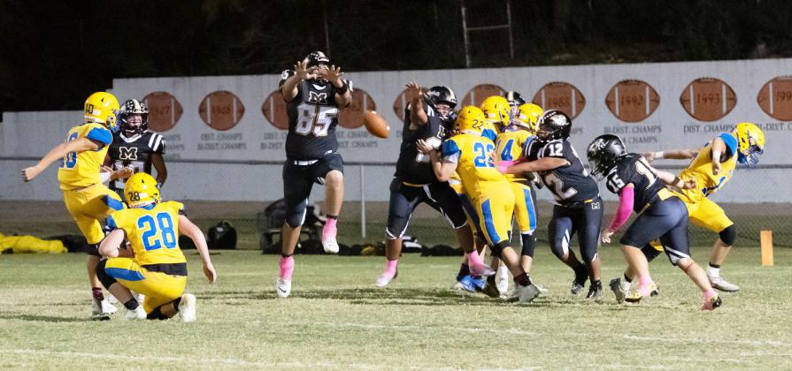 HERE, KITTY KITTY- Yellowjacket Aidan Ramon (#65) gets in the middle of a Medina Bobcat PAT during the Jackets' 80-57 district win at home last week. Hunter Squiers, Zeke Hernandez, Dario Gonzales, and Korbin Squiers are pictured left to right. Nora Davis, photo.