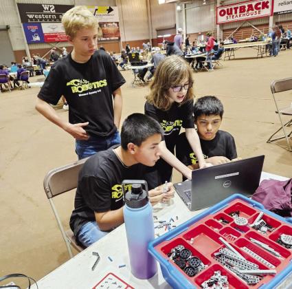 BELOW- Roy Mews, Ayden Cardenas, Barret Thigpen and Isidrio Valdez, of Menard’s junior ag-robotics team, work together during the San Angelo competition. Courtesy photo.