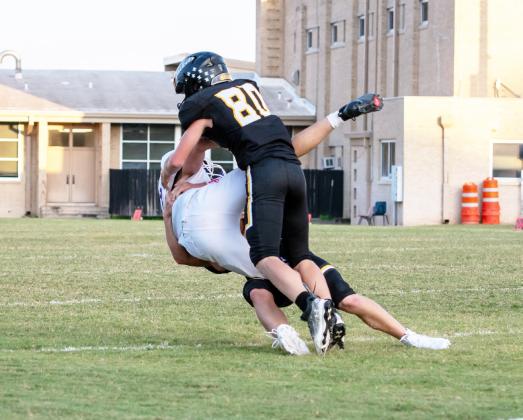 ZONK! Sophomore Cade Bannowsky (80) teams up with sophomore Benjamin Burch (legs) for a take down against Irion County JV last week.