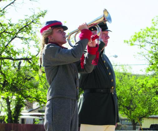 ABOVE- Taylor McCrory plays Tapps at the recent Decoration Day veteran rememberance at Menard’s Pioneer Rest Cemetry. Col. Terry Kelley (Ret.) salutes. Volunteers gathered to place flags upon the graves of the veterans at rest in the cemetery. Photo by Carl Laning. View additional event photos by Laning by scanning the QR code.