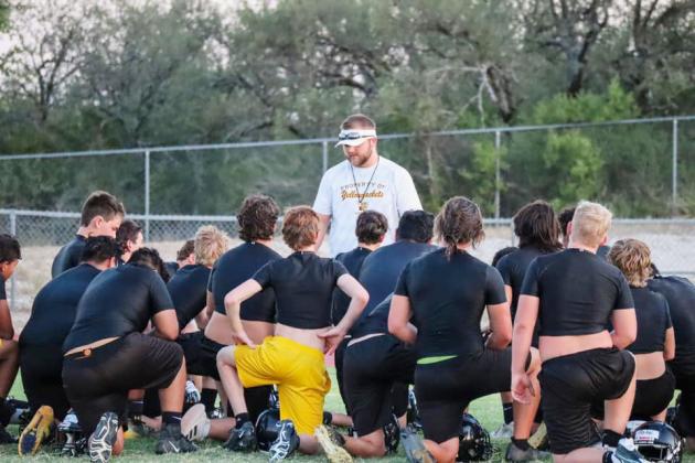 WELL, THAT STINGS. Head football/track coach and athletic director Bryson Oliver addresses a swarm of Yellowjackets in a bygone practice. Oliver unexpectedly accepted an offer to coach the Hornets at Highland ISD (Roscoe), leaving Menard ISD in somewhat of a bind looking toward football season. Oliver went 13-8 in Menard's first two years of six-man football. Laressa Brown, photo.
