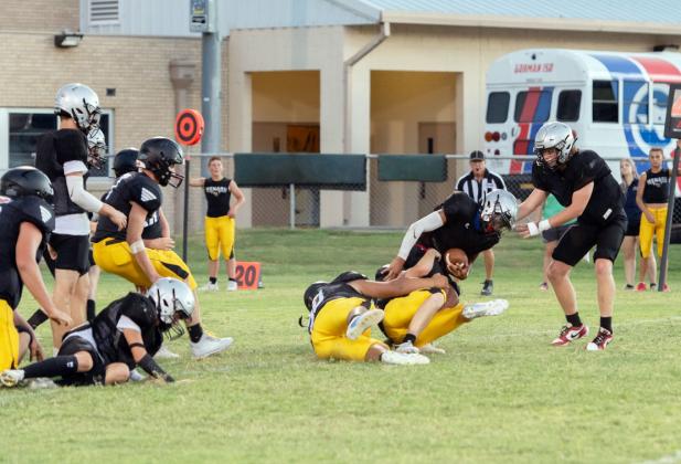 ABOVE- A couple of Yellowjackets team up to take down a Gorman HS ball carrier during the teams' scrimmage last week. The Jackets have their first game of the season this Friday in Blanket.
