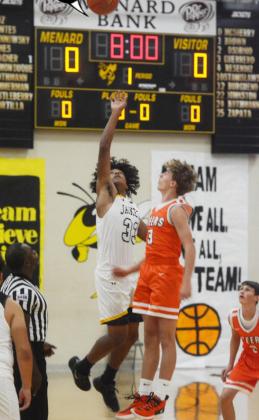 Yellowjacket Isaiah Stanislawski, #33, out-jumps a visiting Steer during the opening tipoff against Robert Lee on November 16 in Menard.