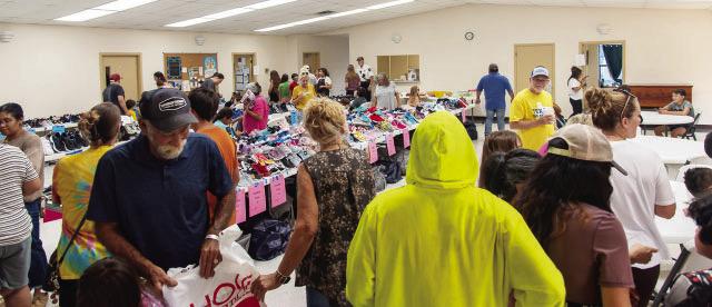MAKING THE GRADE- First Methodist Church of Menard welcomed more than 70 families to their back-to-school event on Monday. Brand new kids' shoes were available for $5/pair. Frontera Healthcare offered free vision screenings and the church provided free school supplies, snacks, and haircuts. Nora Davis, photo.
