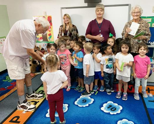 The local chapter of the Texas Retired Teacher’s Association recently donated books to Menard Head Start. John and Katheine Kniffen, far left and far right, presented the books to the students and their teachers- Cydney Petty (back left) and Shelly Valdez (back right). Courtesy photo.