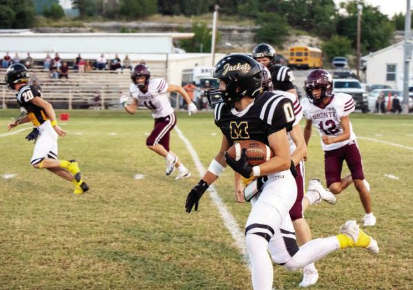 Senior Bryce Davis, far left, clears the way for ball carrier Hunter Squiers on Friday’s win over Bronte.