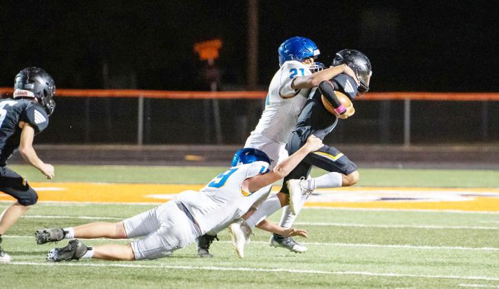 LEFT- JV Maddox Saiz drags a couple of Veribest defenders along for the ride in Menard's win last week. Nora Davis, photo.