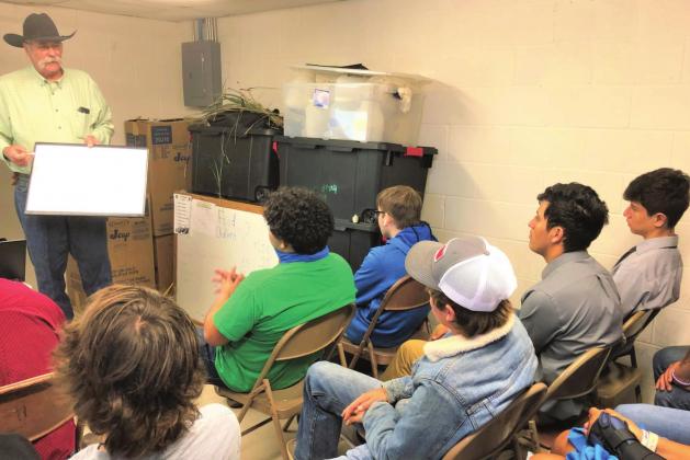 Charles Anderson presents a program entitled “Good Range Depends on Healthy Soil,” to a group of Menard High School students during the Menard County SWCD education day.