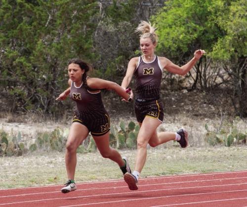 Mackenzie Compton hands off to Perla Pecina in the girls 4x100m relay (second place).