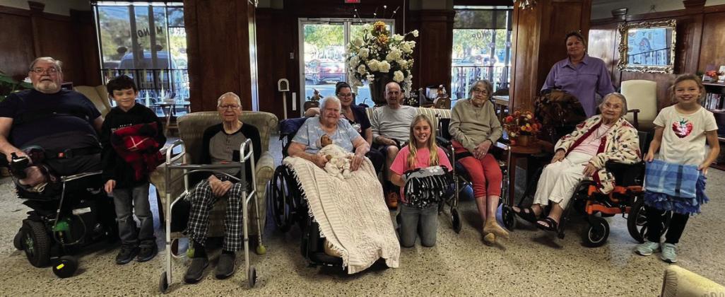 Menard 4-H members made lap knot blankets for residents. Pictured (l to r): Perry Lange, Caeson Lowrance, Wilford Wagner, Edith Nasr, Occupational Therapist Tara, John Bennett, Linah Wright, Laverne Benton, Lisa Brown, Nellie Frnka, and Saydee Meadow. Courtesy Photo.