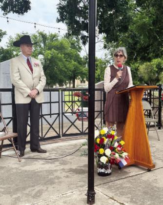 IN MEMORIAM- Terry Kelley, left, joins Christi Gonzales Fairley during a Memorial Day tribute at Menard’s American Legion Park war memorial on Monday, May 26. Fairley is the niece of Private First Class Emiliano G. Gonzalez, United States Army, who was featured at Monday’s program. Courtesy photo.