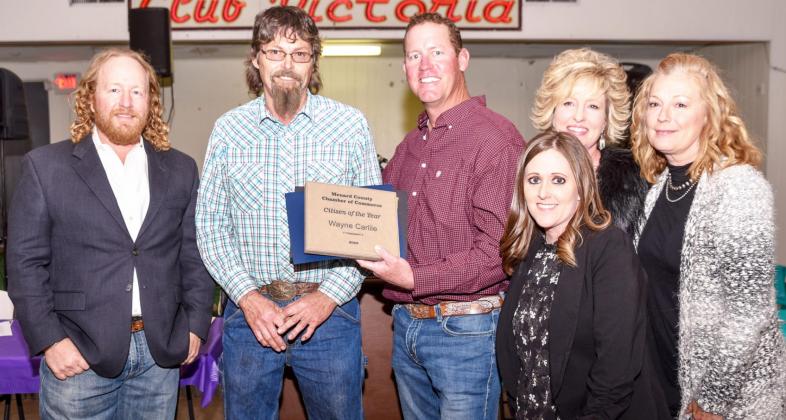 WELL DESERVED- Menard’s Wayne Carlile, second from left, accepts his Citizen of the Year award from Menard County Chamber of Commerce directors (left to right) Cody Swindall, (Carlile), Clint Roberson, Cherry Swindall, Kimberly Powell, and Jessica Rayburn (front). The annual Chamber banquet was held Friday evening, March 11, 2022. Madolyn Nasworthy, photo.