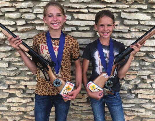 Channing Chambless, left, and Taytum Chambless recently won fi rst place in their respective categories at the 2022 4-H Extravaganza Shooting Event. Courtesy photo.