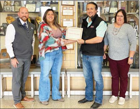 BELTWAY BOUND- Menard High School sophomore Izabella Morales, second from left, accepts a trip certificate from Southwest Texas Electric Co-op representative Neil Cooper. Southwest EC has been hosting this trip for Texas teens since 1965. Also pictured are Menard High School Principal Jacob Hand, far left, and MHS counselor Felicia Laxon. Courtesy photo.