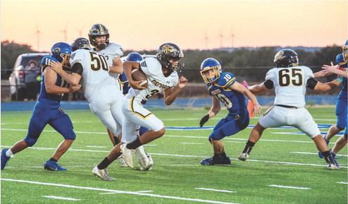 SEE YA- Sophomore Yellowjacket Jayden Payton, center, takes advantage of good blocks from Logan Powell (back), Aidan Ramon (#50), and Jadon Torres (#65) in Priddy last week. The Jackets 45'd the Pirates at the half last week, 49-0. Nora Davis, photo.