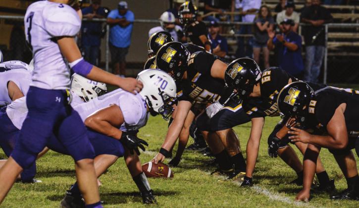 SET HUT! The Yellowjacket offensive line faces the Cross Plains Buffaloes. Pictured are, right to left: Amos Hesbrook (#50); Ulises Osornio (#65); Gavin Johnston (#52); Jonathan Saucedo (#51); Jimmy Morris (#67). Menard lost to Cross Plains 14-33, in a contest mired by lighnting delays. Sandy Kothmann, photo.