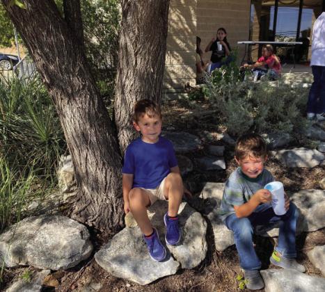 Clover kids Haiden Hand and Deacon Compton stop to enjoy a free snow cone at Tuesday’s Menard 4-H Enrollments rally. The library and gardens were teeming with activity as adult leaders helped guide youngsters to 4-H activities they could choose to join. Courtesy photo.