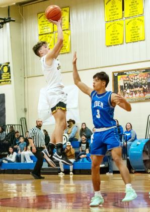 ABOVE- Eli Weatherly shoots over an Eden defender in the Jackets' 43-41 overtime win on Jan. 9. RIGHT- Sabri Zamora works for the ball during the Jan. 9 Lady Jacket victory over the Eden Lady Bulldogs.