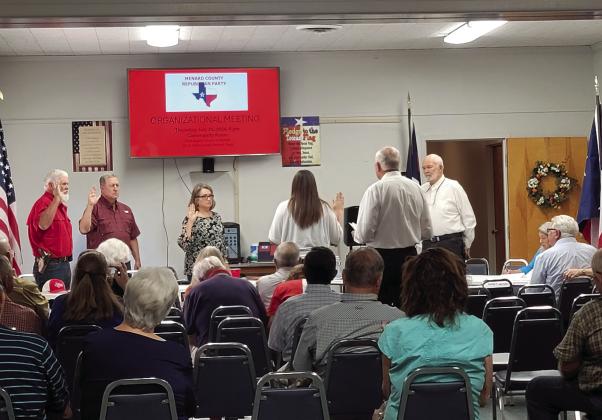 The Menard County Republican Party meeting begins with swearing- swearing in new officers that is. Justice of the Peace Stacy Lawler (middle) gave Barry Kniffen, Gary Roberson, Ginger Hill, and Tom Compton the oath of office, while chairman Randy Corbin presided over the meeting. Courtesy photo.