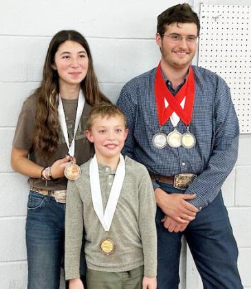 Mia Estrada, Walker Hines and Larkin Loeffler show off their medals at the 2024 Heart of Texas indoor match. Courtesy photo.