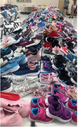 The First Blessing ministry brought hundreds of shoes from sizes infant to 12 and beyond for the shoe blessing at Monday’s back-toschool event. TMN photos.