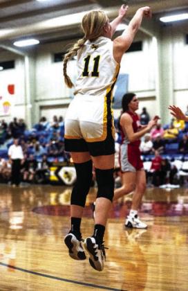 Senior Addy Bannowsky shoots a three, in a game that reselmbled a battlefield at times, against Miles.