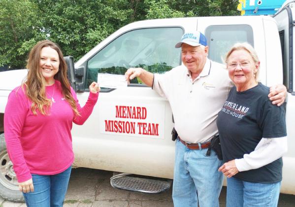 Katie Simmons Parker (left), Houston's sister, presents a memorial donation to Steve Whitson with the Menard Mission Team. Katie and Whitson are joined by mama Simmons, Marga (far right). Courtesy photo.