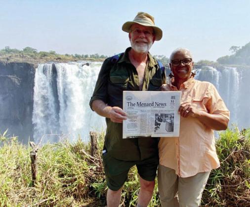 TMN SPOTTED IN AFRICA- Dave and Delise Rohret did not let a recent trip to Africa get them behind on local news. Here they are pictured with The Menard News at one of the viewing stations on the Zimbabwe side of Victoria Falls, across from the country of Zambia. Thanks for thinking of us, Dave and Delise!