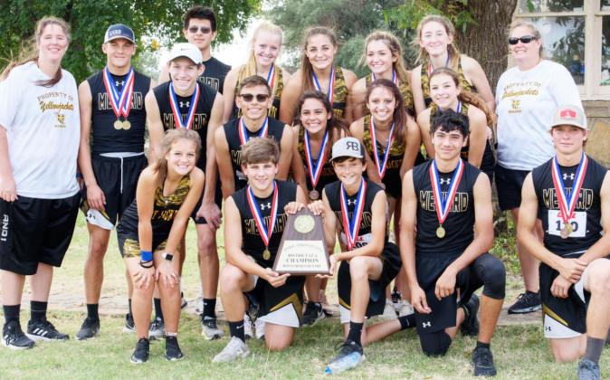 CHAMPS!- MHS cross country teams, with the boys displaying their district champion trophy. L-R, front: Chloe Whitson, Kade Rayburn, Roy Brown, Kolton Whitaker, Houston Hayes. Middle row: Wyatt Terrell, Kevin Johnson, Tatum Ruiz, Hailey Ruiz, Kendal Lawler. Back row: Coach Samantha Bell, Joel Guerrero, Christian Condarco, Addy Bannowsky, Makinley Kothmann, Korah Mayfield, Ayden Matlock, Coach Nancy Saller. Nora Davis, photo.