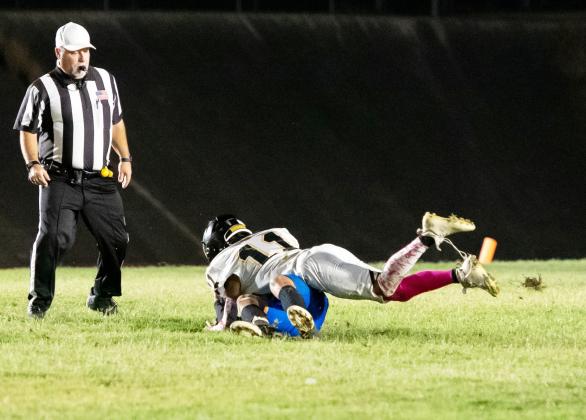 SACK-ZILLA- Yellowjacket Maddox Saiz, #11, gets a good clean shot on the Medina quarterback during Menard’s district win last week.
