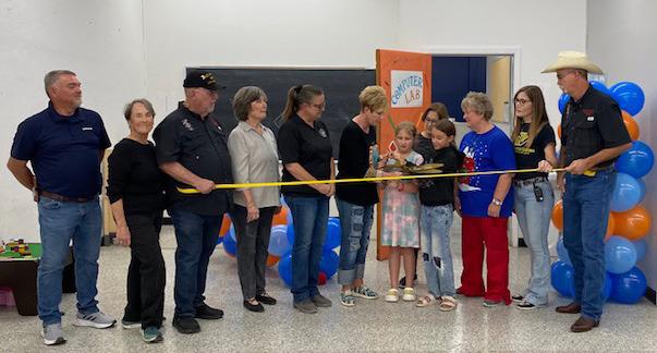 Optimum representatives, Boys &amp; Girls Club Board members, and Club staff are joined by Menard Chamber of Commerce directors to cut the ceremonial ribbon which signified the official opening of the new, state-of-the-art computer lab at the Club. All aspects of the lab were provided by Optimum- from renovations to equipment. Courtesy photo.