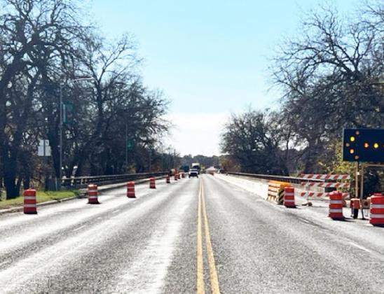 LEFT- The Highway 83 bridge through Menard, looking southbound. Concrete barriers and barrels are up, constricting lanes from 4 to 2 lanes as construction crews begin a rehabilitation project. TMN photo.