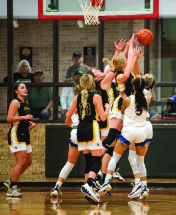 A SWARM OF LADY ‘JACKETS- work to block the shot in an intense game against state ranked Veribest. Lady ‘Jacket photos by Sandy Kothmann.