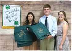 GOLD STARS ALL AROUND! Mia Estrada, left, and Cado Bannowsky accept their prestigious Gold Star Awards at the awards banquet. The Gold Star is the highest honor bestowed upon a 4-H member. Also pictured is 4-H Coordinator Haley Anderson. See additional awards banquet photos on page 7. Photo courtesy Menard 4-H.