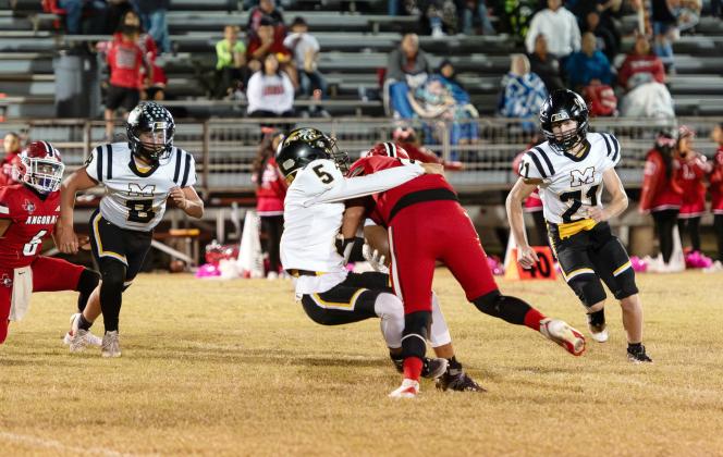 SOPHOMORE SWARM- Mack Davis (#8), Marlee Salas (#5), and Kade Bannowsky (#21), all sophomores, zero in on an Angora ballcarrier in Rocksprings last week. The 48-44 non-district win provided valuable opportunities for the team's talented underclassmen to gain some quality playing time. A win for the undefeated Jackets in Eden this Friday will claim the outright district championship to finalize the regular season. See additional football photos on page 8. Photo by Nora Davis.