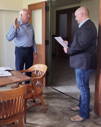 Newly elected (George) Randy Corbin repeats the oath of office as the new County Chair of the Menard County Republican Party. County Judge Brandon Corbin, Randy's son, administered the oath on Monday. TMN photo.