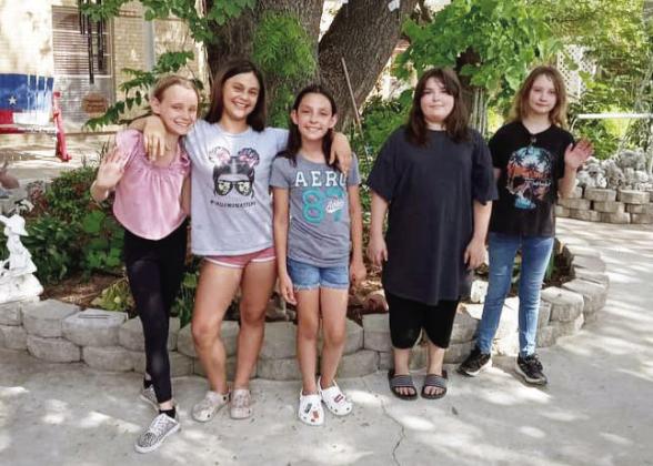 JUNIOR GIRLS SCOUT TROOP #5253, left to right: Aerie Meddaugh, Sara Ogden, Kelsie Aguirre, Avery Schuler, and Molly Brown. The troop planned and executed their project by purchasing and planting flowers at Menard Manor last week. Not pictured: Kayla Trimble and Nayeli Hernandez. Courtesy photo.