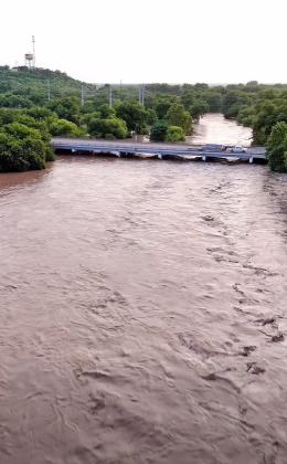 the San Saba River near its peak rise on Friday evening, July 17, 2026, looking east to west, from just above the low water crossing in town. Photo by Rafter N Media.