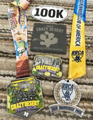 LEFT- Sandy Kothmann's award haul after winning the womens' master division of Saturday's Crazy Desert 100k Trail Race in San Angelo. Courtesy photo.